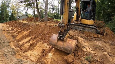 using a mini excavator for ditching|digging drainage ditch with excavator.